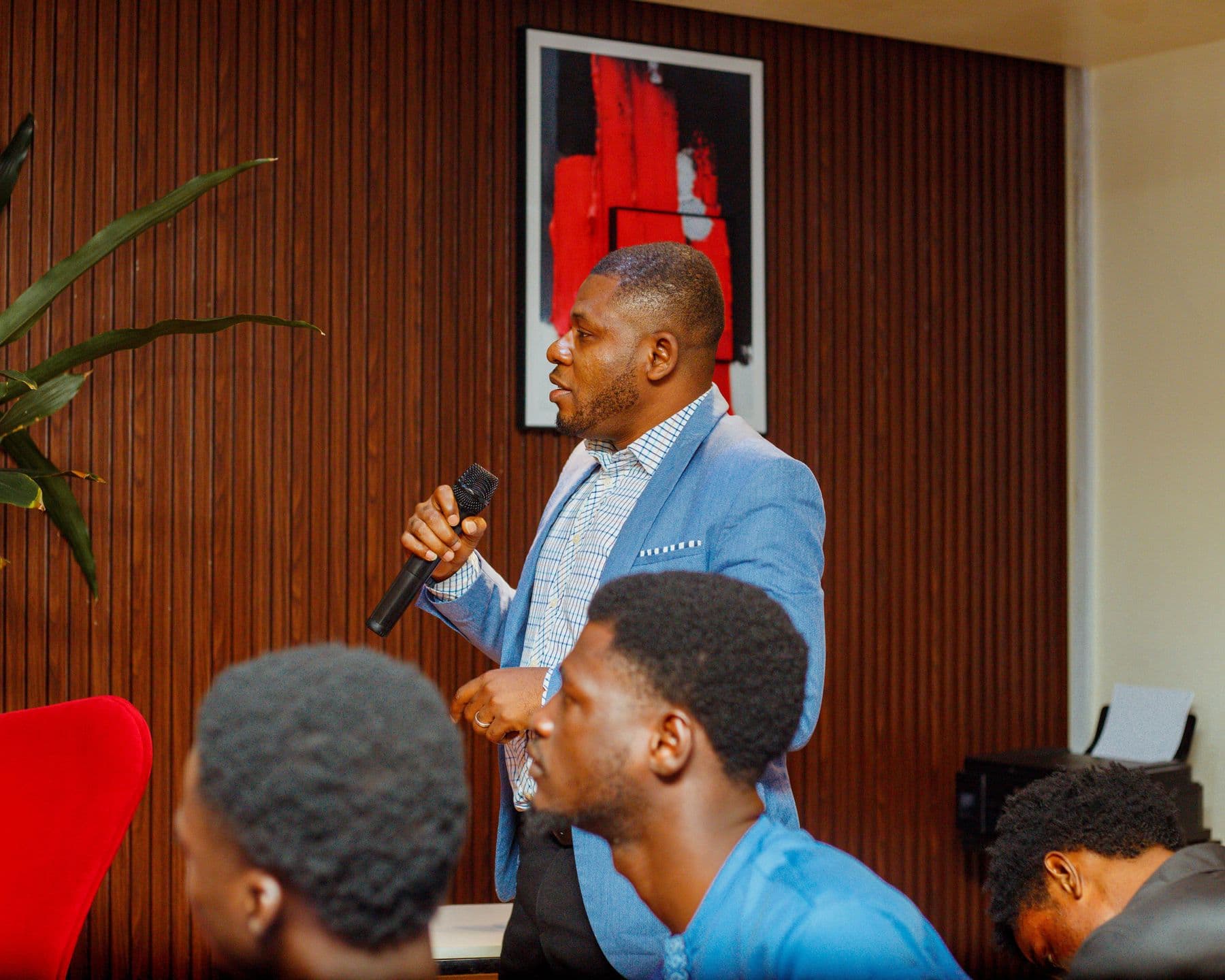 A speaker engages founders seated in the front row
